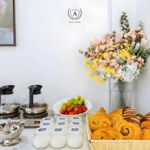 a table topped with bread and a vase of flowers at Sala Lan Anh hotel in Phước Long
