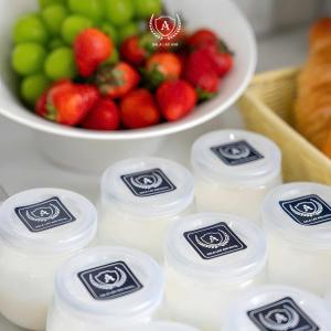 a pile of milk next to a bowl of fruit at Sala Lan Anh hotel in Phước Long +1 photo