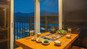 a table with a tray of food and drinks on a balcony at Gapyeong Arom Spa Pension in Gapyeong