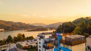 a building with a view of a river and mountains at Gapyeong Arom Spa Pension in Gapyeong