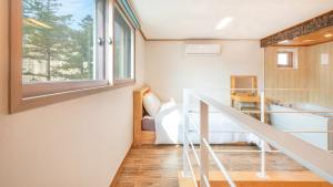 a room with a staircase and a bed and a window at Gapyeong Arom Spa Pension in Gapyeong