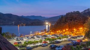 a parking lot next to a lake at night at Gapyeong Arom Spa Pension in Gapyeong +2 photos