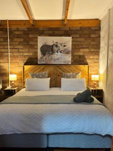 a bedroom with a large bed with a brick wall at Mount Gerizim Farm in Louisvale
