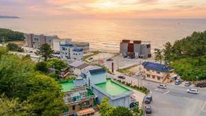 an aerial view of a city with the ocean at Goseong Araenmaru Pension in Goseong