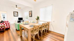 a dining room with a table and chairs at Teke Cottage in Wooli