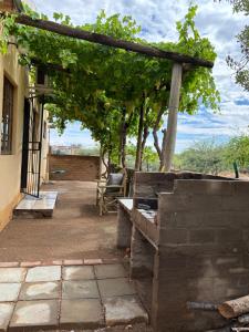 an outdoor patio with a pergola and a bench at Mount Gerizim Farm in Louisvale
