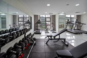 a gym with rows of treadmills and exercise bikes at Tao Dan Hotel in Ho Chi Minh City