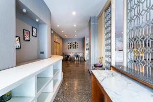 a hallway with a counter and a room with a window at Krabi Royal Hotel in Krabi