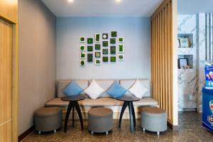 a bench with two tables and two stools at Krabi Royal Hotel in Krabi