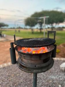 a bbq grill with a pot of fire at Caysa Villa in Gaborone