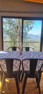 a table and chairs in a room with a window at Loft La Misión in Salta