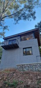 a house with a balcony on top of it at Loft La Misión in Salta