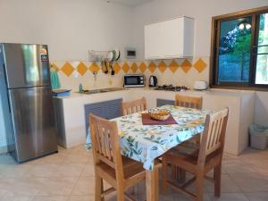 a kitchen with a table with chairs and a refrigerator at Sabai Residence in Ao Nang Beach