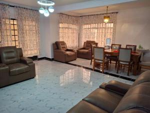 a living room with furniture and a dining room table at BlessRoyal Home in Kitengela  +17 photos