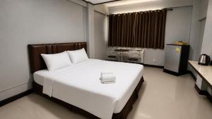 a bedroom with a large white bed with a box on it at Happyland Mansion in Bangkok +27 photos