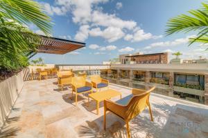 a patio with chairs and tables on a building at Syrena Multi Listing in Playa del Carmen