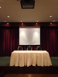 a meeting room with a white table and a projection screen at Chada Veranda Hotel in Ban Si Than +79 photos