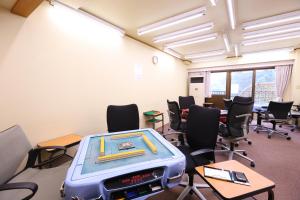 a classroom with a ping pong table and chairs at Yugawara Chiyodasou in Yugawara +59 photos