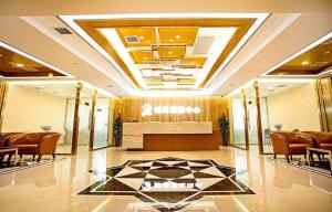 a lobby with a table and chairs in a building at Teda Dalian in Dalian +287 photos