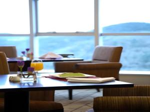 a table with a glass of orange juice on it at Teda Dalian in Dalian