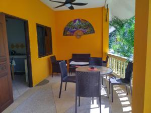 a dining room with yellow walls and a table and chairs at Sabai Residence in Ao Nang Beach +15 photos