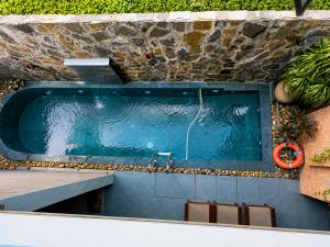 a swimming pool in a stone wall with a swimming pool at Daisy's Villa TamCoc in Ninh Binh
