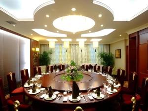a conference room with a large table with chairs at Changchun Global Hotel in Changchun