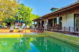 a pool of water in front of a building at Cha Am Villa Beach in Cha Am