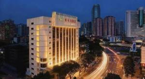 a lit up building in a city at night at Guangna Hotel in Huizhou