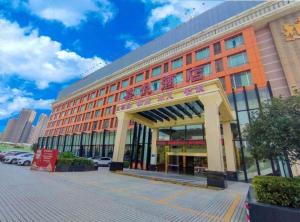 a large orange building with a sign in front of it at Cheerful Hotel in Nanhai