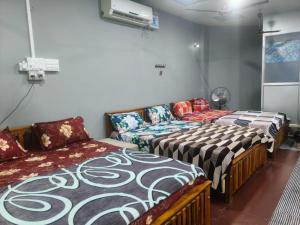 two beds and a couch in a room at Maha Periyava Kuteeram 10 Adults Budget Stay in Kumbakonam +40 photos