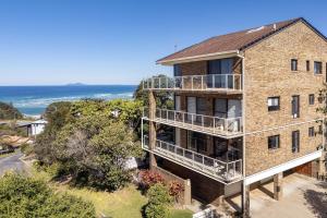 an aerial view of a house with the ocean in the background at Ocean Retreat in Nambucca Heads
