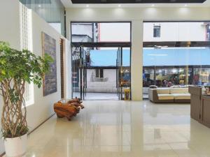 a large lobby with a large window and a couch at Mount Emei Fulin Hotel in Baoguosi