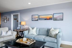 a living room with a couch and a table at Ohana in Holden Beach