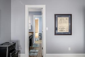 a hallway with a picture of a boat on the wall at Ohana in Holden Beach +34 photos