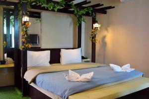 a bedroom with a bed with white butterflies on it at Z2 Boutique Hotel in Ban Samet +156 photos