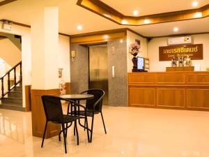 a waiting room with a table and chairs in a hospital at Loei Residence in Ban Tha Phae