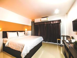 a hotel room with a bed and a window at Mukdaview Hotel in Mukdahan