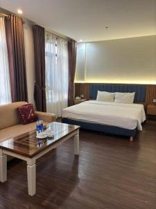 a hotel room with a bed and a coffee table at Smart Hotel in Bắc Ninh +259 photos