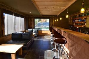 a bar with a couch and chairs in a room at Hotel Valley Thimphu in Tshalunang