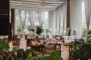 a large room with chairs and tables and windows at Centre Point Da Nang City Hotel - Afternoon Tea Inclusive in Danang +55 photos