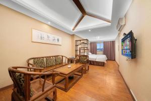 a living room with a couch and a table at BOOK PAVILION HOTEL in Dongguan