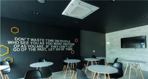 a room with tables and chairs and a tv at Seven bee boutique hotel in Surin +62 photos