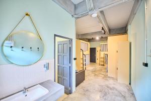 a bathroom with a sink and a mirror at Noodle Shop Hostel in Nathon Bay +31 photos