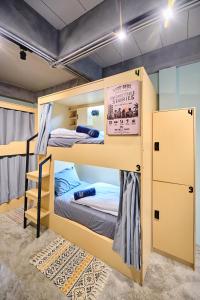 a bunk bed room with two bunk beds in it at Noodle Shop Hostel in Nathon Bay