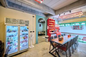 a dining room with a table and chairs and a store at Noodle Shop Hostel in Nathon Bay