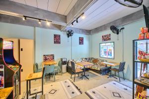 a room with tables and chairs in a store at Noodle Shop Hostel in Nathon Bay