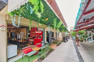 a store with plants on the side of a street at Noodle Shop Hostel in Nathon Bay