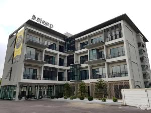 an office building with a sign on top of it at @Sleep in Ban Rang Faet