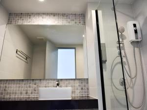 a bathroom with a sink and a shower with a mirror at @Sleep in Ban Rang Faet